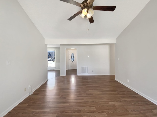 unfurnished living room with visible vents, baseboards, dark wood-style flooring, and a ceiling fan