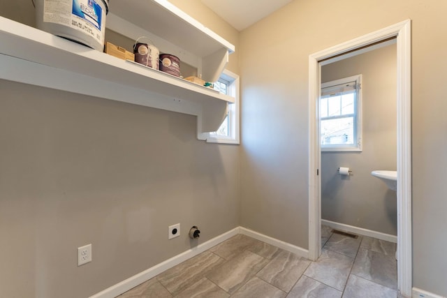 washroom featuring laundry area, visible vents, baseboards, and hookup for an electric dryer