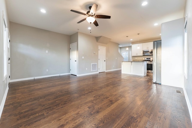 unfurnished living room featuring recessed lighting, visible vents, a ceiling fan, and dark wood-style flooring