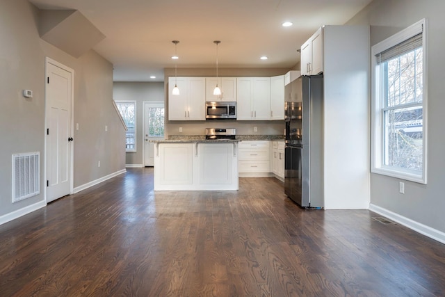 kitchen with visible vents, recessed lighting, appliances with stainless steel finishes, white cabinetry, and dark wood-style flooring