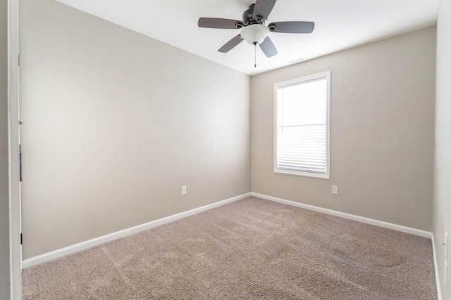 spare room with baseboards, carpet, and ceiling fan