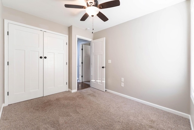 unfurnished bedroom with a closet, ceiling fan, baseboards, and carpet floors