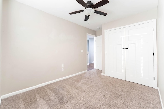 unfurnished bedroom featuring a closet, ceiling fan, baseboards, and carpet