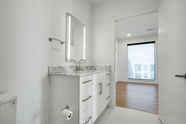 bathroom featuring tile patterned floors, toilet, and vanity