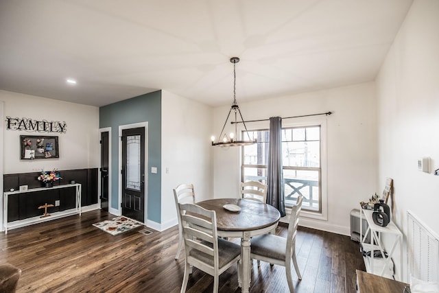 dining area featuring visible vents, baseboards, a chandelier, and dark wood-style flooring