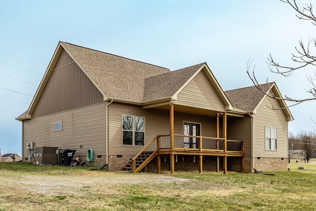 rear view of house featuring a yard, central AC, a shingled roof, stairs, and crawl space