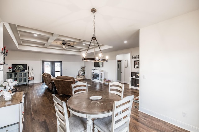 dining space featuring dark wood-style floors, baseboards, coffered ceiling, beam ceiling, and french doors