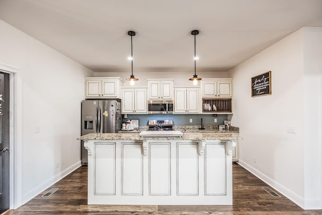 kitchen featuring light stone counters, a center island with sink, stainless steel appliances, and dark wood-type flooring