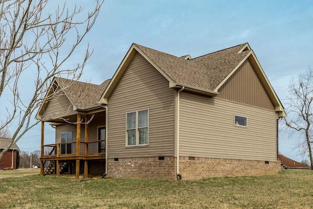 view of property exterior with crawl space, a deck, a yard, and roof with shingles