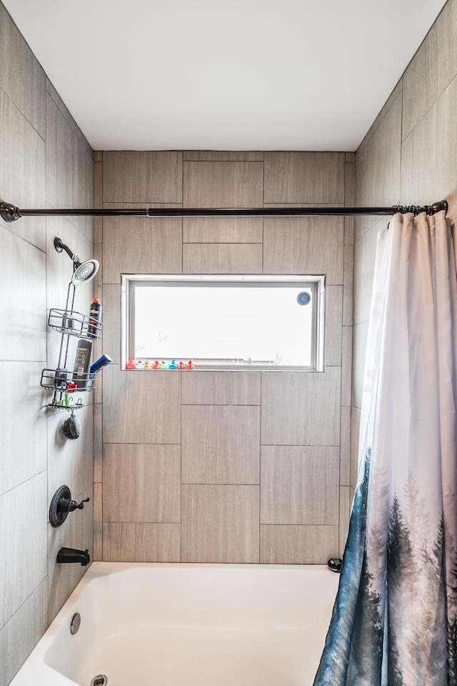 full bath featuring a wealth of natural light and shower / tub combo with curtain