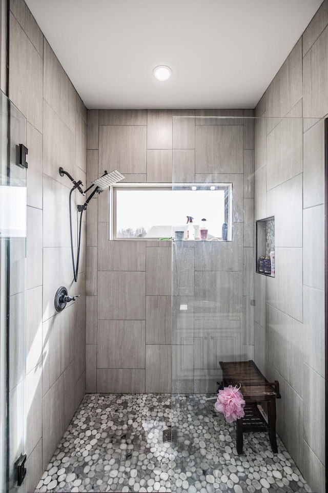 bathroom with a tile shower