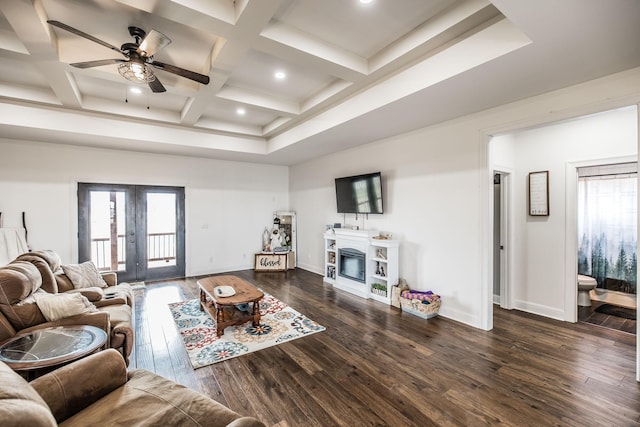 living area with baseboards, french doors, dark wood-style floors, a glass covered fireplace, and coffered ceiling