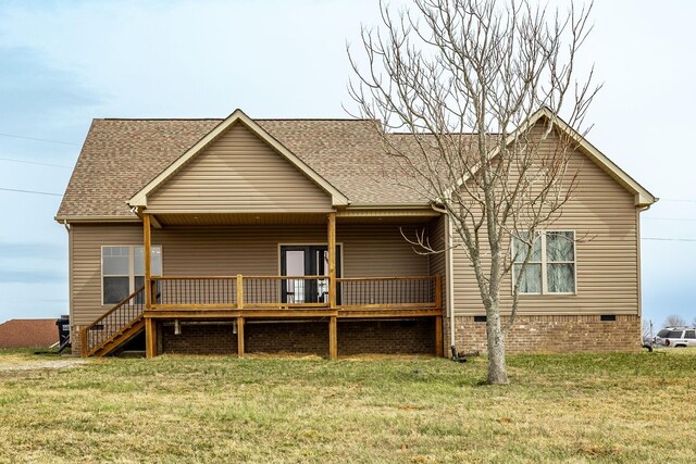 rear view of property featuring stairway, a yard, a shingled roof, crawl space, and a deck