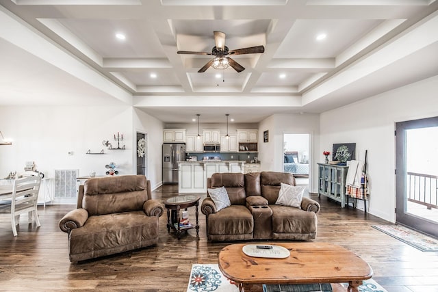 living area with beamed ceiling, a ceiling fan, coffered ceiling, baseboards, and dark wood-style flooring