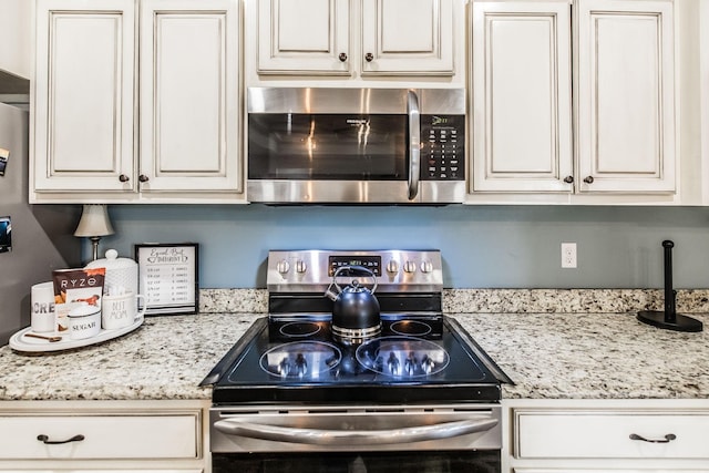 kitchen with light stone counters and stainless steel appliances