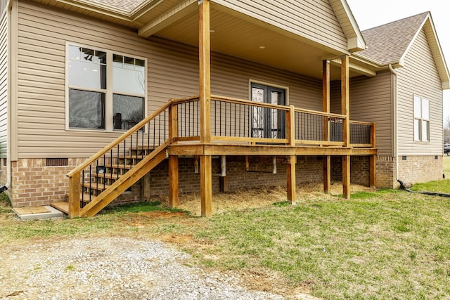 rear view of house with a shingled roof, stairs, and crawl space