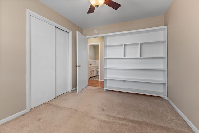 unfurnished bedroom with a ceiling fan, carpet, and baseboards