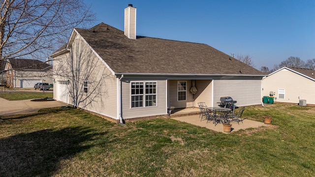 back of property with a lawn, central AC, roof with shingles, a chimney, and a patio area