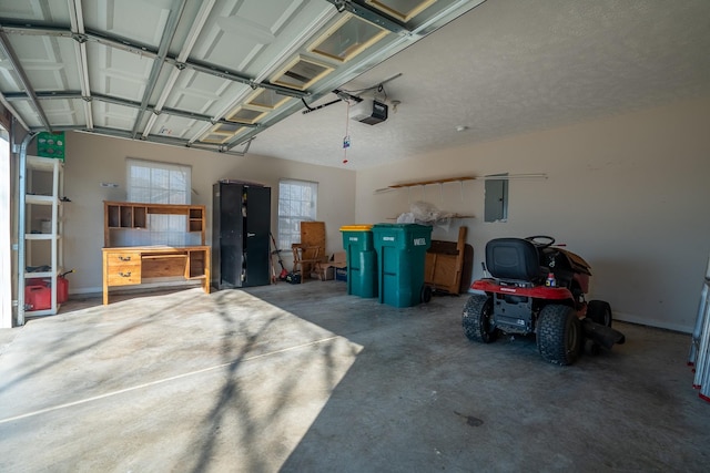 garage featuring electric panel and a garage door opener