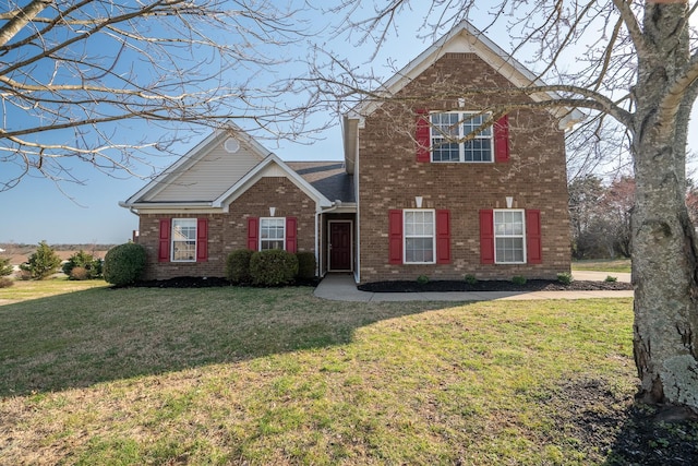 traditional home featuring brick siding and a front yard