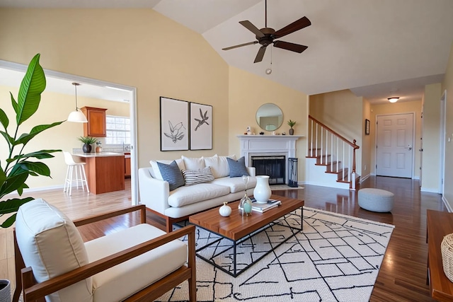 3000 Ping Ct, Spring Hill, TN 37174 - living area featuring a ceiling fan, light wood-style flooring, stairs, a fireplace, and high vaulted ceiling