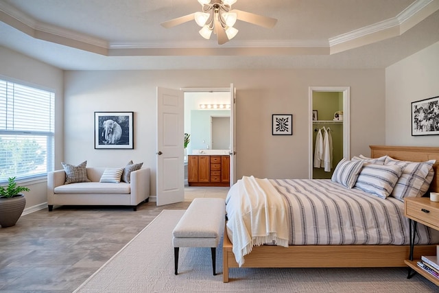 3000 Ping Ct, Spring Hill, TN 37174 - bedroom featuring a tray ceiling, crown molding, a walk in closet, ensuite bath, and baseboards