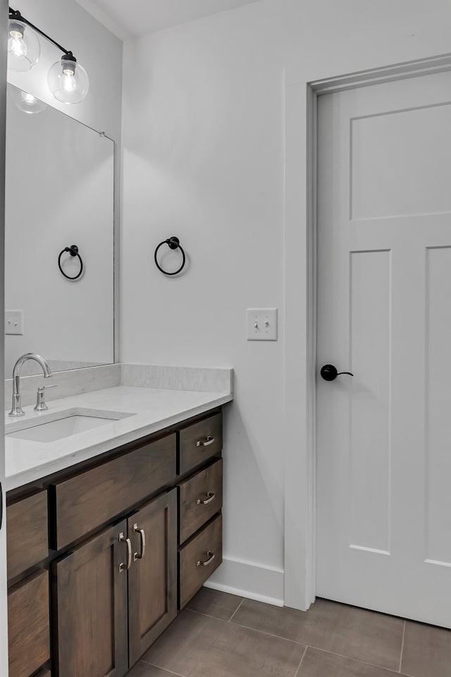 bathroom featuring vanity, tile patterned floors, and baseboards