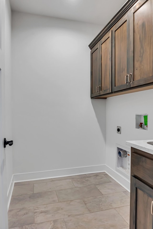 laundry room with cabinet space, hookup for an electric dryer, baseboards, and washer hookup