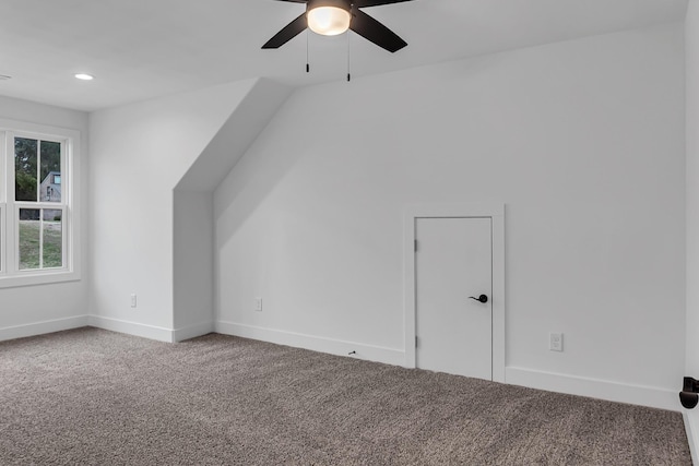 bonus room featuring baseboards, lofted ceiling, carpet, and a ceiling fan