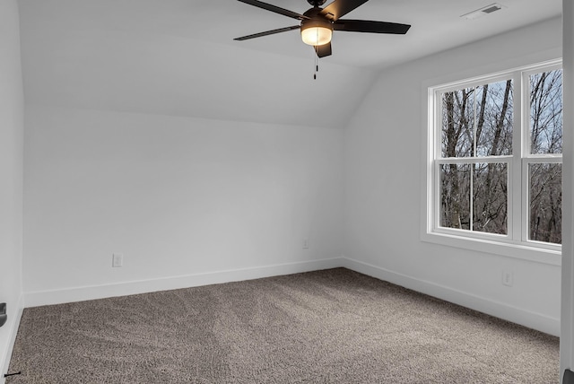 additional living space featuring visible vents, baseboards, lofted ceiling, and carpet floors