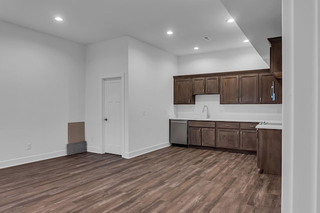 kitchen featuring dishwasher, light countertops, recessed lighting, and dark wood-style flooring