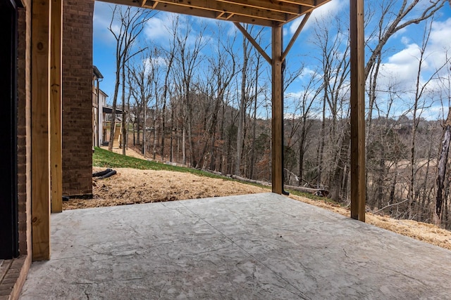 view of patio with a forest view