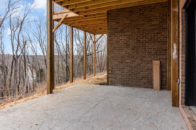 view of patio with a view of trees