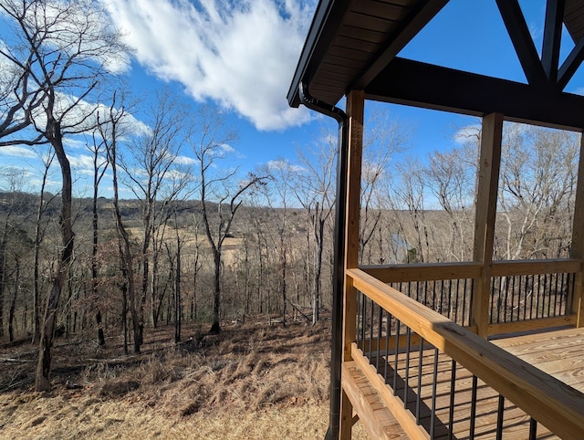 wooden deck with a forest view