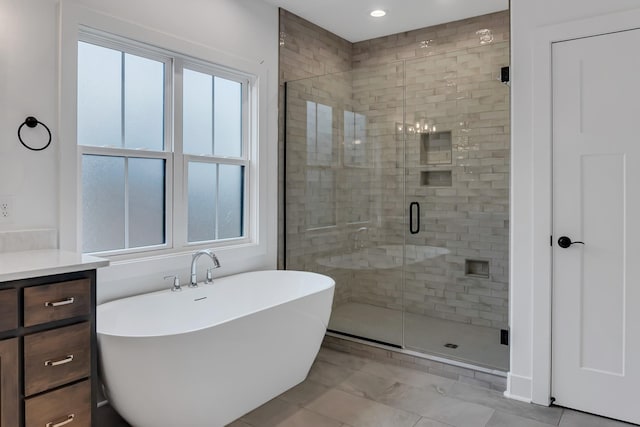 full bathroom featuring recessed lighting, a stall shower, vanity, and a freestanding tub