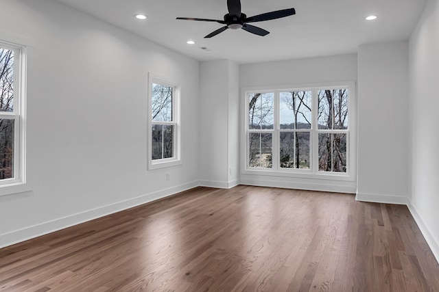 empty room with visible vents, ceiling fan, baseboards, recessed lighting, and wood finished floors