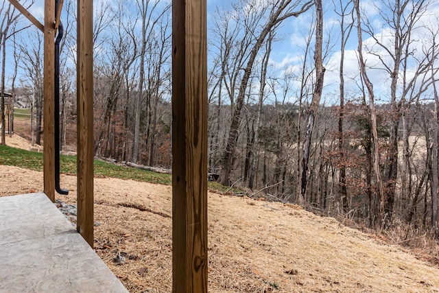 view of yard featuring a forest view