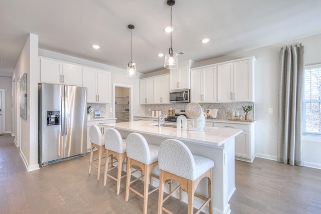 kitchen with stainless steel appliances and white cabinetry