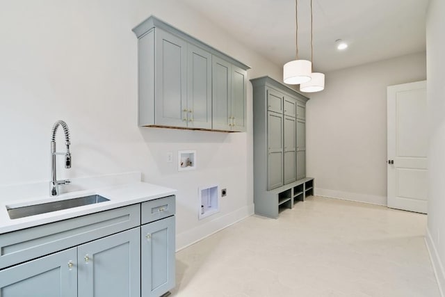 laundry area with a sink, cabinet space, baseboards, hookup for an electric dryer, and hookup for a washing machine