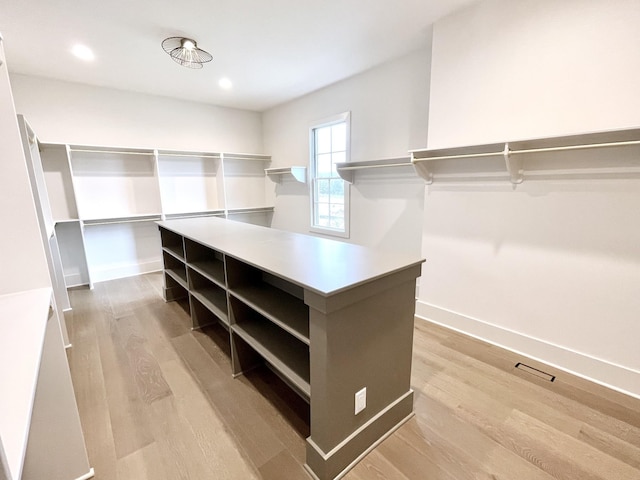 walk in closet featuring light wood-style flooring