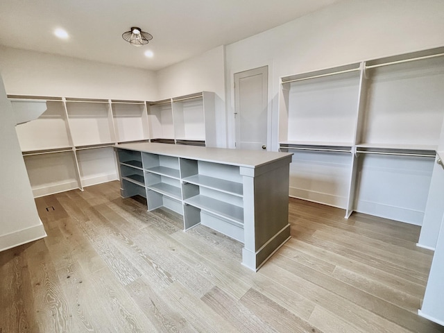 walk in closet featuring light wood-style flooring