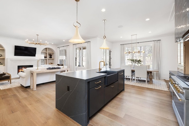 kitchen featuring a notable chandelier, crown molding, and a sink