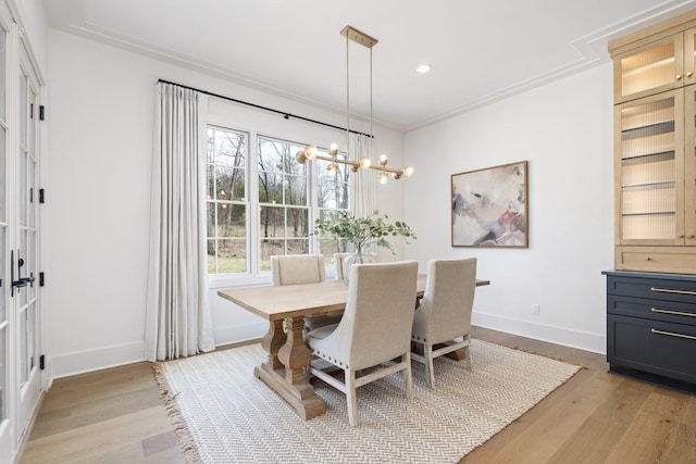 dining space featuring recessed lighting, baseboards, a notable chandelier, and light wood finished floors