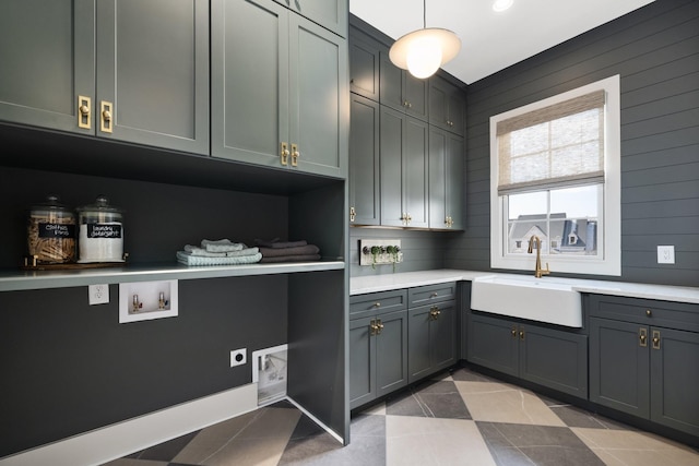 kitchen with tile patterned flooring, light countertops, gray cabinets, and a sink