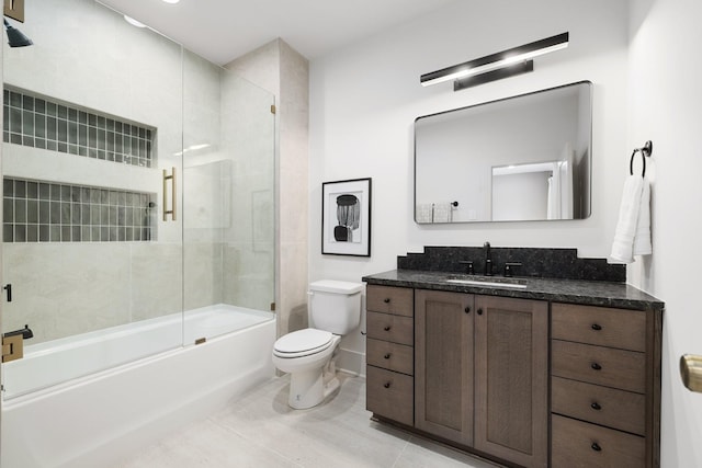 full bathroom with tile patterned floors, combined bath / shower with glass door, toilet, and vanity