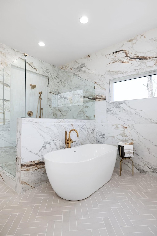 full bath with a freestanding tub, recessed lighting, and a marble finish shower