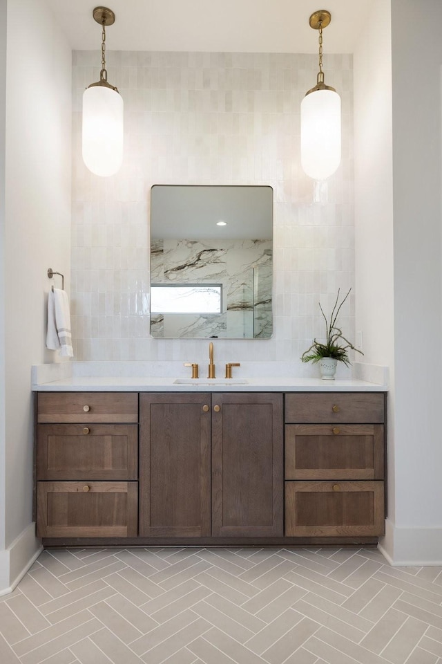 full bath with a shower, baseboards, and vanity