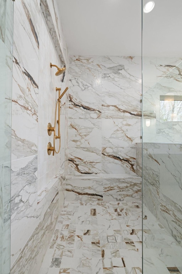 full bathroom with a marble finish shower