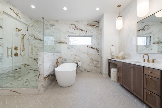 full bathroom with vanity, a marble finish shower, a freestanding tub, recessed lighting, and a wealth of natural light