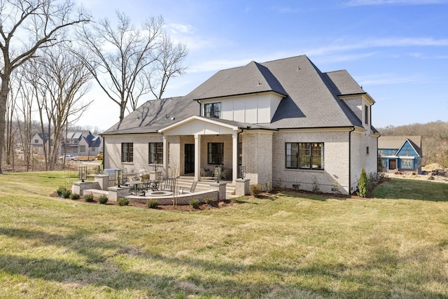 rear view of property with brick siding, board and batten siding, crawl space, a yard, and a patio area